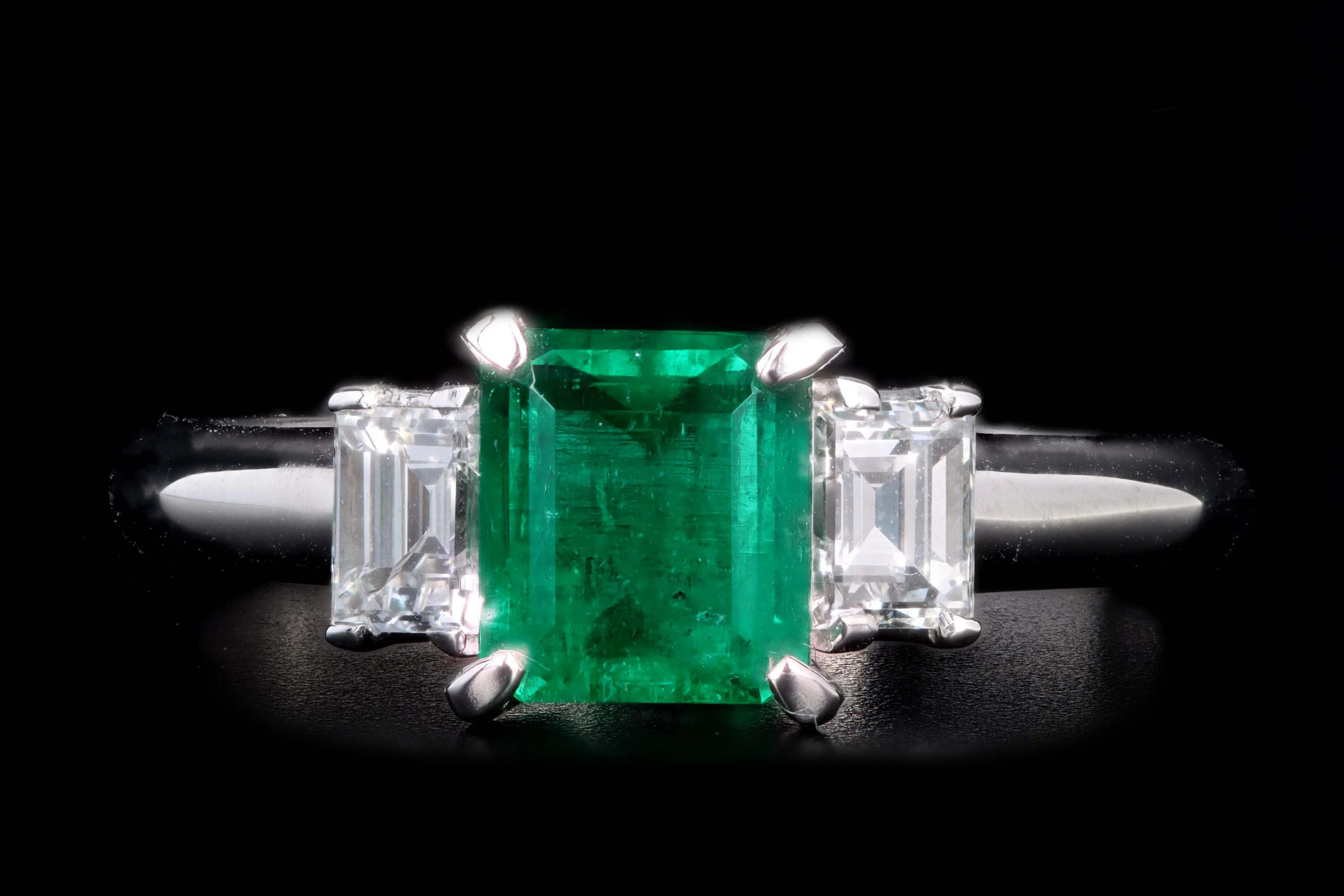 Modern Platinum .77 Carat Emerald & Diamond Ring